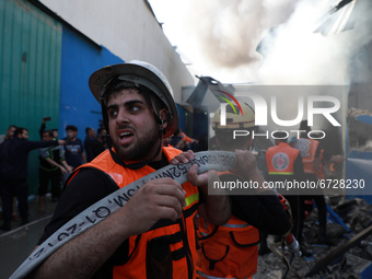 Palestinian firefighters douse a huge fire at the Foamco mattrss factory east of Jabalia in the northren Gaza Strip, ofollowing Israeli air...
