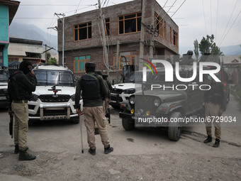 Indian forces stand near encouter site in Khonmuh area of Pampore district south of Srinagar, Indian Administered Kashmir on 17 May 2021. Tw...