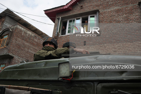 Kashmiri people watch as Indian forces leave from encouter site in Khonmuh area of Pampore district south of Srinagar, Indian Administered K...