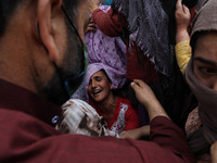Kashmiri women wail outside the damaged residential house after encounter between Indian Forces and Alledged militants was over in Khonmuh a...