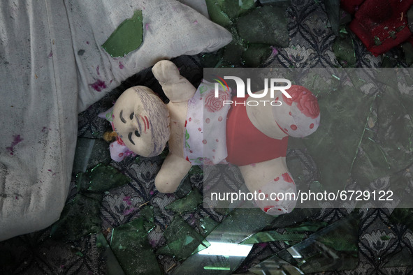 A doll lies on broken window panes inside damaged residential house after encouter between Indian forces and Alledged militants came to end...