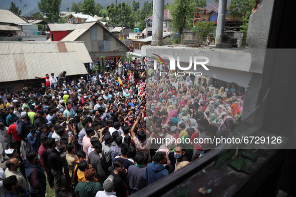Kashmiri people shout pro-freedom slogans outside the damaged residential house after encounter between Indian Forces and Alledged militants...