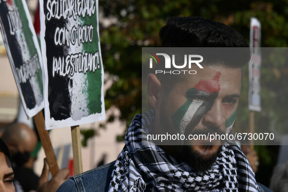 A protester carries a flag painted on his face in support of Palestine during a rally in Lisbon. May 17, 2021. The Portuguese Council for Pe...