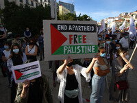 Demonstrators carrying banners in support of Palestine shout slogans against Israel during a rally in Lisbon. May 17, 2021. The Portuguese C...