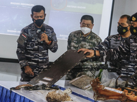 Indonesian Navy officer Rear Admiral of TNI Iwan Isnurwanto (left) shows some parts of sunken Indonesian Navy submarine KRI Nanggala 402 dur...