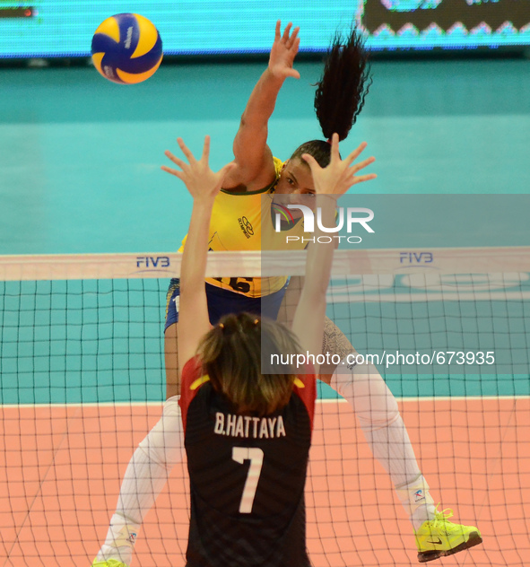 Fernanda Rodrigues (Top) of Brazil spikes the ball as Thailand player attemp to block during their FIVB World Grand Prix intercontinental ro...