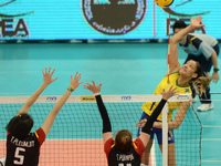 Joyce Silva (Top) of Brazil spikes the ball as Thailand players attemp to block during their FIVB World Grand Prix intercontinental round ma...