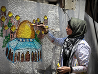 Palestinian artist Etaf al-Najili paints Al-Aqsa Mosque's Dome of the Rock in Jerusalem, on a remaining wall section of a damaged building i...