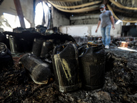 A Palestinian worker salvages items from a damaged factory in Gaza's industrial area, on May 25, 2021, which was hit by Israeli strikes prio...