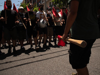  A student is holding a red flag during a protest  in Athens, Greece, on May 27, 2021. (