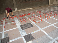  A student is spray painting a slogan at the street in Athens, Greece, on May 27, 2021. (