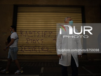 A man is watching the protesters in Athens, Greece, on May 27, 2021. (