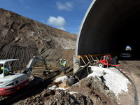 Workers use an excavator during the construction of a tunnel for the $2.7 billion, 170-mile Brightline high-speed rail extension from South...