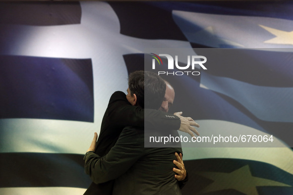 Newly appointed  Finance minister Euclid Tsakalotos (R) with outgoing Yanis Varoufakis during the handover ceremony at the ministry