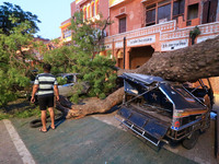  Vehicles damaged under an uprooted tree following a heavy storm at Kishanpole Bazar in Jaipur, Rajasthan, India, Sunday, May 30, 2021.(