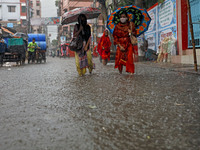 People walk on the street in the rain at morning in Dhaka, Bangladesh on June 01, 2021. Heavy monsoon downpour causes extreme water logging...
