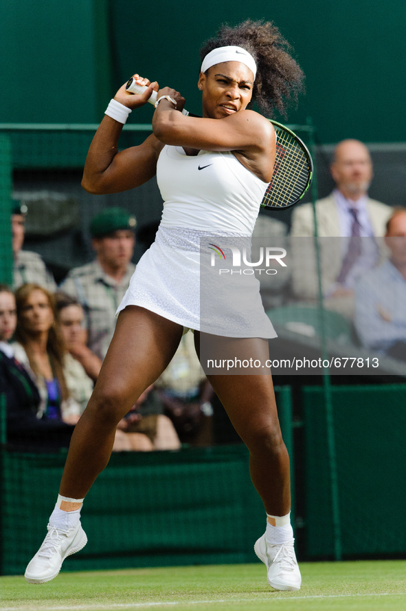 Serena Williams seen playing with power and determination as she overcomes Viktoria Azarenka in three sets during day eight of the Wimbledon...