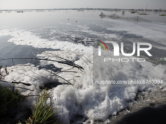 White foam are seen during overflowing the polluted Asem Binatul river, in Pekalongan, Central Java province, on June 4, 2021. According to...