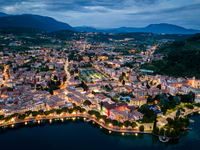 A drone view of Garda, Italy, on June 5, 2021, during the sunset.  Lake Garda is the largest lake in Italy and a popular holiday location in...