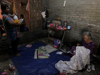 Mrs Waryuni (70), continue to work on her batik cloth manually at her home after the tidal flood receded in jeruk sari village, Pekalongan c...