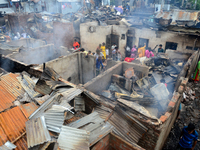 Bangladeshi Slum-dwellers have seen searching for their household belongings after a devastating fire that broke out at Mohakhali slum in Dh...