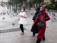 Three women are walking wearing protected mask near Monastiraki square in Athens, Greece on June 9, 2021. (