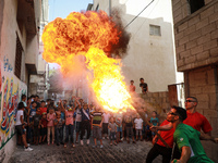 Palestinian members of Gaza's Bar Woolf sports team perform fire breathing as an entertainment for children at the Beach refugee camp, in Ga...