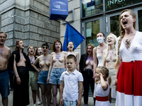 (EDITOR'S NOTE: This image contains nudity.) Belarusians and pro-Belarusian activists gathered in front of Warsaw's European Commission offi...
