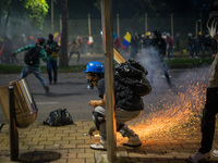 Riot police clash with demonstrators during a protest against the government of Colombian President Ivan Duque in Medellin, Colombia on June...