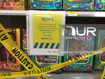 Yellow caution tape blocks aisles with goods not allowed to be sold at a Walmart store during the novel coronavirus (COVID-19) pandemic in T...
