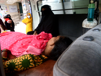 A suspected Covid-19 patient waits inside an ambulance in front of Dhaka Medical College Hospital for treatment in Dhaka, Bangladesh, on Jun...