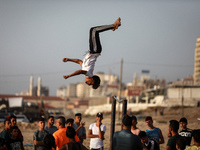 A Palestinian man demonstrates his parkour skills on a beach, in Gaza City, on June 11, 2021.
 (
