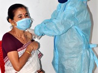 A medic administers a dose of COVID-19 vaccine to a  woman  at a vaccination centre in Guwahati, India on June 12,2021. (