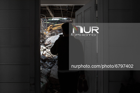 Homeowner sees his damaged house. A landslide at the Griya Satwika Telkom Pisangan housing estate, Ciputat, South Tangerang, Indonesia, on J...