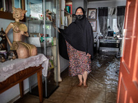 A resident poses at his house which is flooded from the river flow. Floods that hit Nerada Estate housing, Cipayung, Ciputat, South Tangeran...