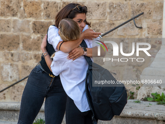 A fifth-year student embraces her friend as she has finished her high-school leaving examination in Rieti, Italy, on June 16, 2021. High-sch...