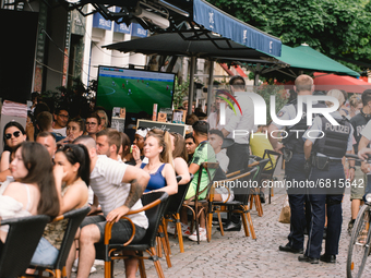 Polices are seen patrolling as fans are watching Euro 2020 match between Portugal and Germany in an outdoor restaurant in Bonn, Germany on J...