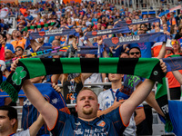 FC Cincinnati fans hold up scarves during the Nation Anthem prior to the start of the MLS soccer match between FC Cincinnati and the Colorad...