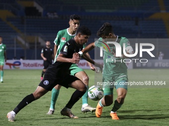 Mohamed Souboul (R) of Raja fights for the ball against a Pyramid's soccer player during CAF Confederation Cup Semi-final match between Pyra...