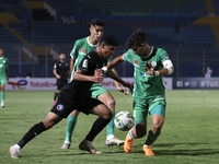 Mohamed Souboul (R) of Raja fights for the ball against a Pyramid's soccer player during CAF Confederation Cup Semi-final match between Pyra...