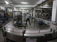 A Palestinian employee cleans an empty production line at the PEPSI factory in Gaza's industrial zone on June 21, 2021. - Israel lifted some...