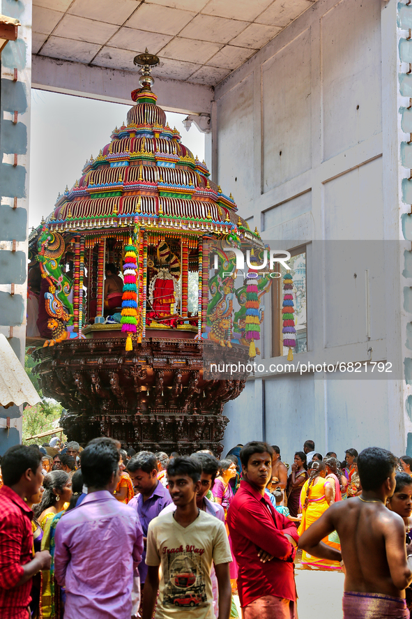 Tamil Hindu devotees stand by the large wooden chariot (ther) while the idol of the Goddess in placed inside during the Amman Ther Thiruvizh...