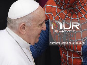 Pope Francis meets Spider-Man, who presents him with his mask, at the end of his weekly general audience with a limited number of faithful i...