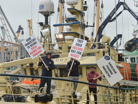 Fishermen protest to increase the share of fishing quotas in Irish waters, while a huge fleet of fishing boats moor along the Liffey River i...