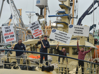 Fishermen protest to increase the share of fishing quotas in Irish waters, while a huge fleet of fishing boats moor along the Liffey River i...