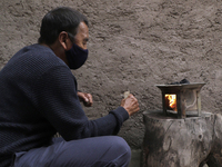 A liturgical member of the San Juan Bautista chapel in Culhuacán, Mexico City, Mexico, on June 24, 2021 burns charcoal in an anafre to be pl...