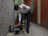 A liturgical member of the San Juan Bautista chapel in Culhuacán, Mexico City, Mexico, on June 24, 2021 burns charcoal in an anafre to be pl...