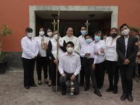 A priest and liturgical team outside the San Juan Bautista chapel in Culhuacán, Mexico City, Mexico, on June 24, 2021 pose after the end of...