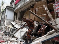 Firefighters and rescuers inspect the scene of a suspected gas explosion in Dhaka, Bangladesh on June 28, 2021.
 (