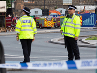 Policemen secure Elephant and Castle station area as a large blaze destroyed several arches in South London, England on June 28, 2021.Two pe...